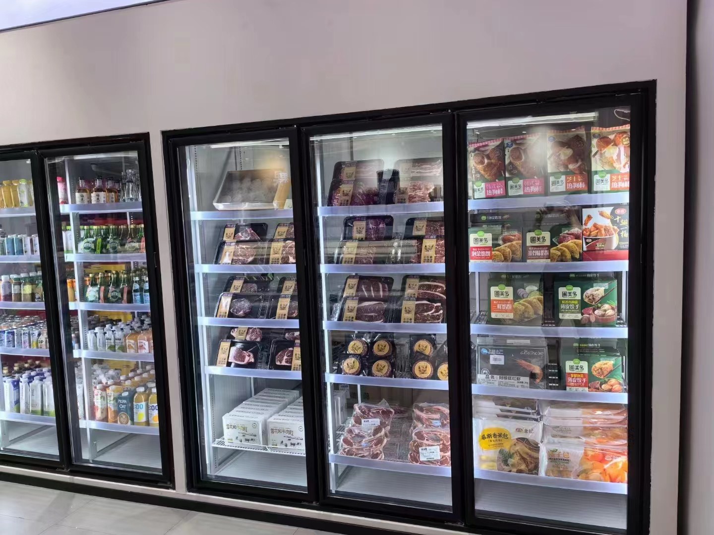 Packaged food is arranged across several shelf levels behind black-framed glass doors. The image shows the stocked display face.